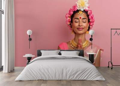 A young woman in a vibrant red and gold sari smiles while adorned with intricate jewellery and a traditional bindi Wall mural