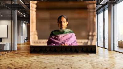 indian woman praying at temple Wall mural