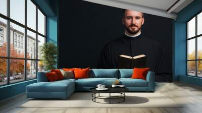 Portrait of Young Catholic Priest Holding Holy Bible, Faith and Clergy Leadership Wall mural