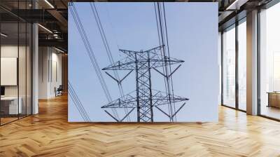 high voltage electric tower and cable against cloudy sky, copyspace on the right Wall mural