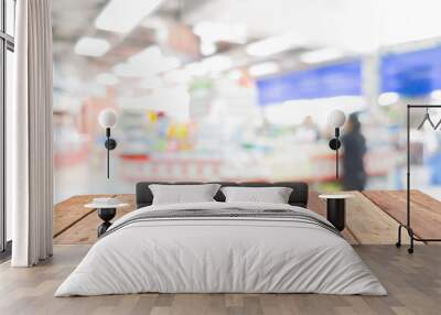 Wooden board empty table in front of blurred convenience store cashier background with bokeh Wall mural