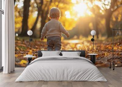 Cute Toddler Boy Walking in Autumn Park with Golden Leaves Wall mural