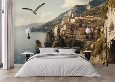 Seagull Flying Over Coastal Village With Cliffs and Ocean View Wall mural