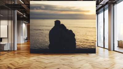 Couple hugging on background beach ocean sunrise, meeting of lovers concept, silhouette two romantic people cuddling on evening seascape, hipster enjoy sunset together, travel holidays vacation relax Wall mural