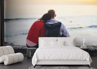 Couple hugging on background beach ocean sunrise, romantic people cuddling and looking evening seascape, hipster with dog enjoy sunset together, travel holidays vacation, love relax concept Wall mural