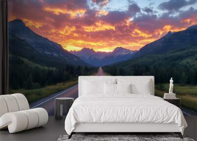 A quiet mountain highway with an asphalt surface, surrounded by towering peaks and a sky filled with vivid sunset colors Wall mural