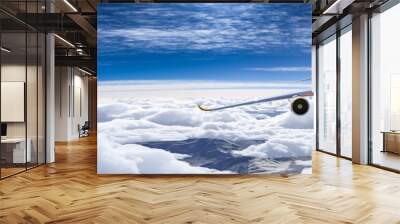 Commercial modern Airliner Airplane flying in the sky above the mountains Wall mural