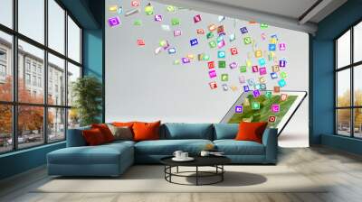 Tablet PC with cloud of application icons Wall mural