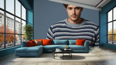 This is a picture of a man wearing a striped sweater. He has brown hair and a beard. Wall mural