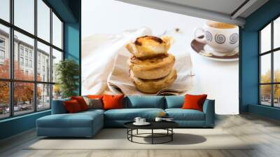 Pasteis de nata, traditional sweet of Portuguese cuisine. Small crunchy puff pastry pies and a cream made with eggs. Often tasted and accompanied with coffee. On white background, copy space. Wall mural