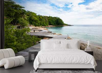 Wooden pathway built on a rocky coast  at Koh Munnork island , Rayong, Thailand. Wall mural