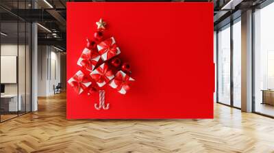 Christmas tree made of gift boxes and decoration on red background. Creative idea concept. 3d rendering Wall mural