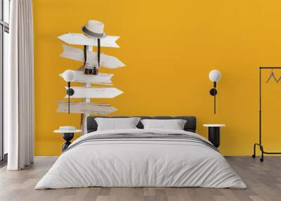 Hat and camera with signpost on yellow background. Travel concept 3d rendering Wall mural