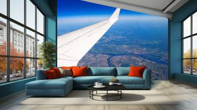 Airplane wing view of the city sky blue clouds earth journey Wall mural