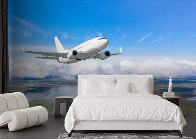 Commercial airplane flying above cloudscape in day toned sun light. Wall mural