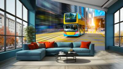 Double decker city shuttle bus drives motion blur rapid speed effect along route line among buildings on the street of megapolis Wall mural