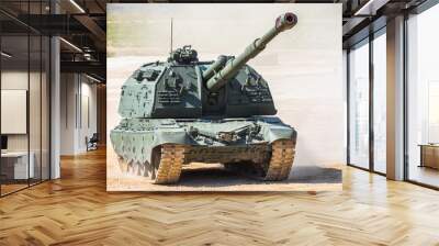 heavy armor tank with dust from under the caterpillars in the field of battle. Wall mural