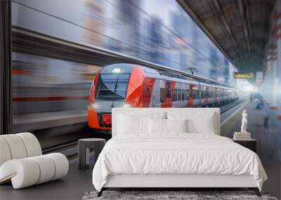 High speed train rides at high speed at the railway station in the city. Wall mural