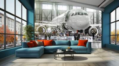 passenger aircraft on maintenance of engine and fuselage repair in airport hangar. Wall mural