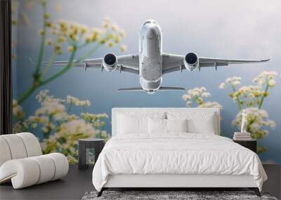 Passenger commercial airplane flies over flower fields at the airport. Wall mural