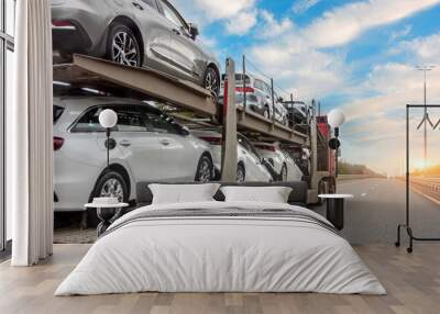 Transportation of new and very expensive cars. Hauling cars trailer and truck pulls rides on the highway. Wall mural