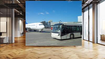 White passenger bus for transporting people from the terminal building to the aircraft ramp during the flight departure procedure. Wall mural