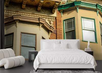 Two exterior bay window spires on side of modern brown stone building with flat roofs and decorative paint Wall mural