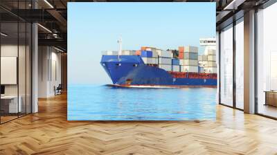 Large cargo container ship sailing in an open sea on a clear day. Panoramic view. Freight transportation, global communications, logistics, industry, business, economy, environmental damage Wall mural