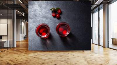 Ginjinha or Ginja - Tradition Portuguese liqueur. Two alcohol cherry shot on dark background, top view. Selective focus Wall mural