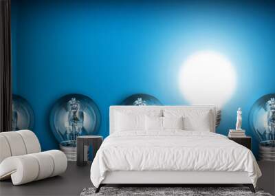 Idea concept with row of light bulbs and glowing bulb Wall mural