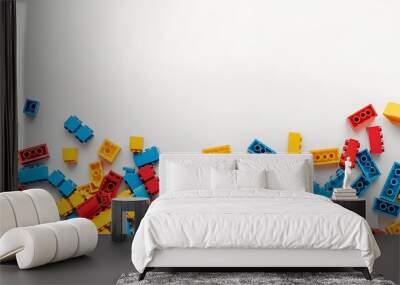 Colorful Plastic Building Blocks Scattered on White Background Wall mural