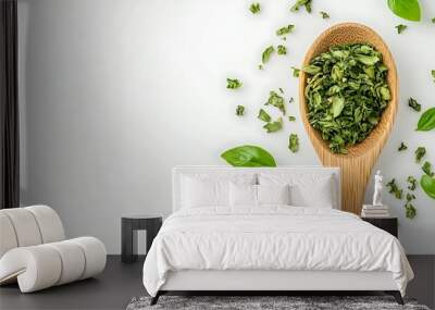 Dried Basil Leaves in Wooden Spoon on White Background Wall mural