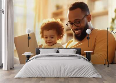 Professional photo of a man sitting on the sofa of his home with in front of a laptop while working from home Wall mural