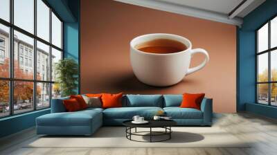 white cup of tea on brown background Wall mural