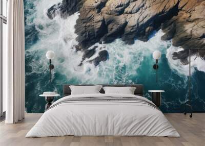 Waves crashing on a rocky coastline seen from above Wall mural