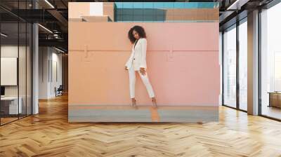 Female model in white suit posing Wall mural