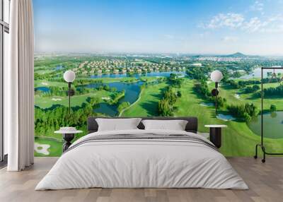 Aerial photograph of forest and golf course Wall mural