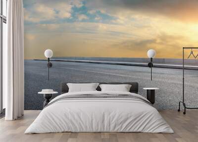 Asphalt highway and beautiful clouds landscape at sunset Wall mural