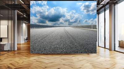 Asphalt highway ground and blue sky with white clouds scene. Wall mural