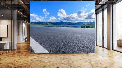 Asphalt highway road and green mountain nature landscape under blue sky Wall mural