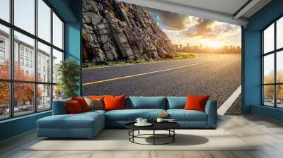 Asphalt highway road and mountain with city skyline at sunset Wall mural