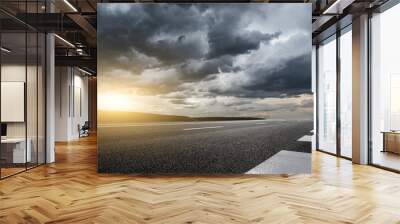 Asphalt highway road with black rain clouds natural landscape before the rainstorm Wall mural