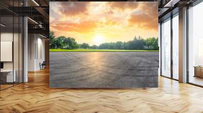 Asphalt race track and green woods nature landscape at sunset Wall mural