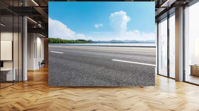 Asphalt road and beautiful mountain with lake under the blue sky Wall mural