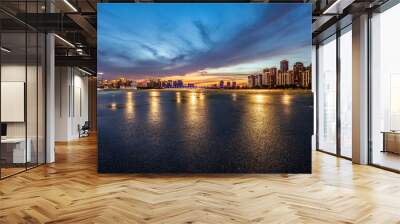 Asphalt road and city skyline with modern building at night in Suzhou, China.  Wall mural