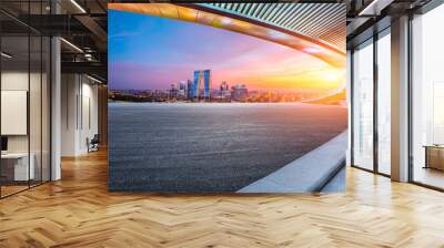 Asphalt road and city skyline with modern building at sunset in Suzhou, Jiangsu Province, China. Wall mural