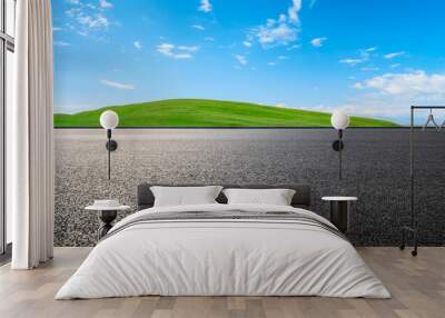 Asphalt road and green mountain nature landscape under blue sky Wall mural