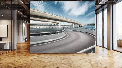 Asphalt road and highway bridge under the blue sky Wall mural