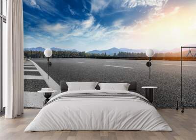 Asphalt road and hills with sky clouds landscape at sunset Wall mural