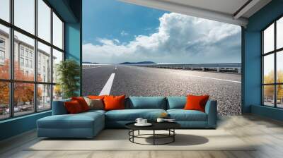 Asphalt road and river with mountain nature landscape under blue sky Wall mural